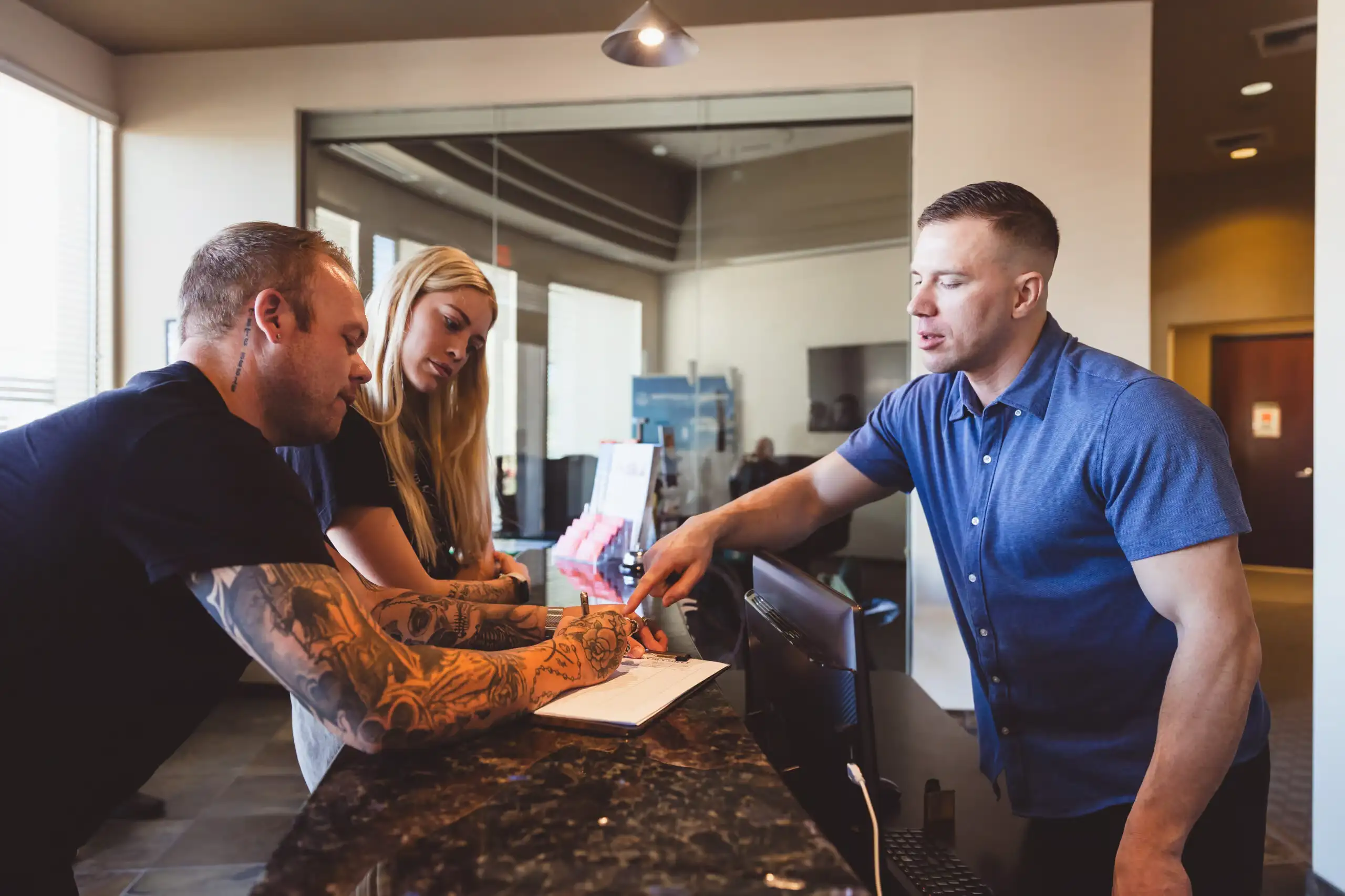 Clients checking in with a team member at the Recovery Room front desk