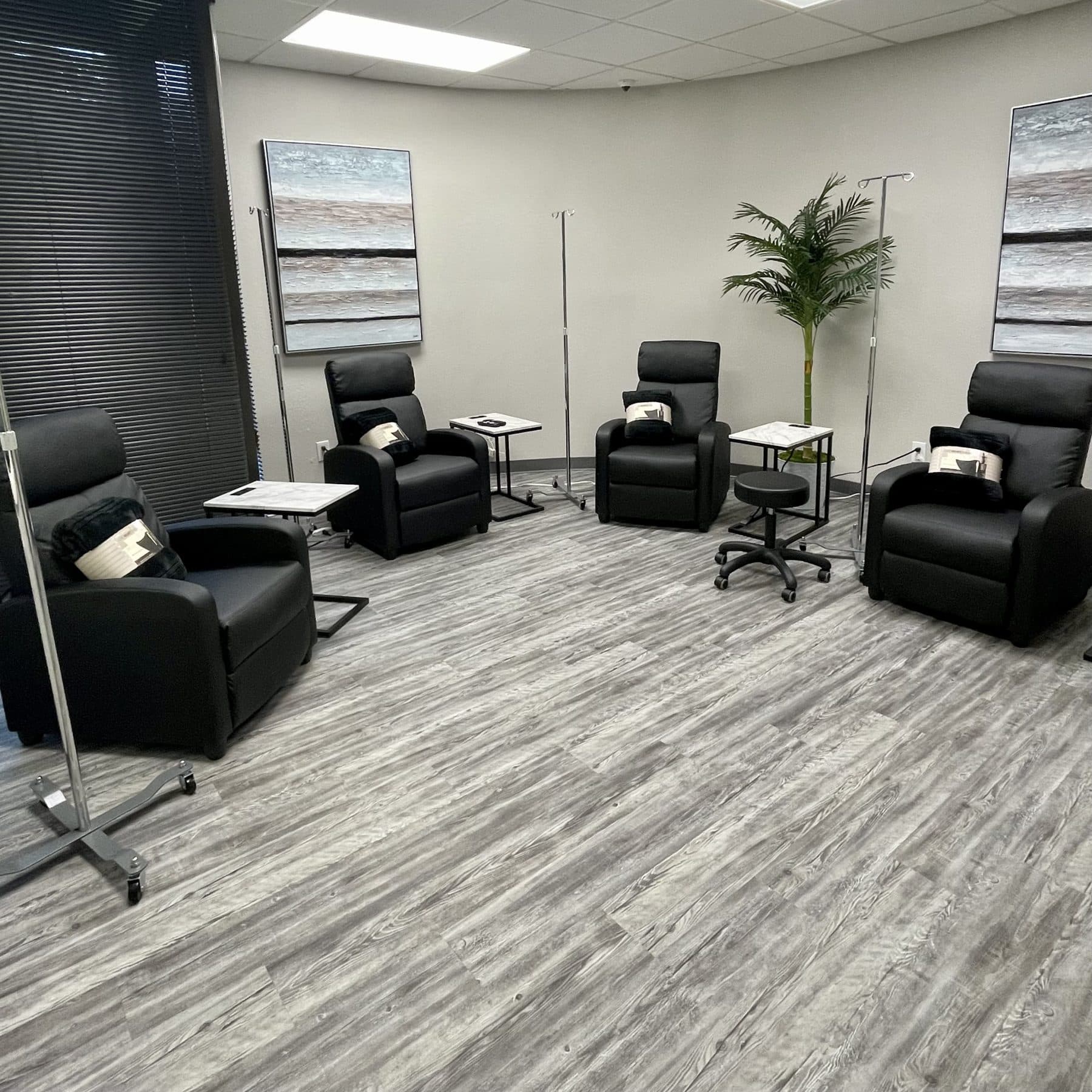 The Recovery Room treatment room with recliners and IV stands